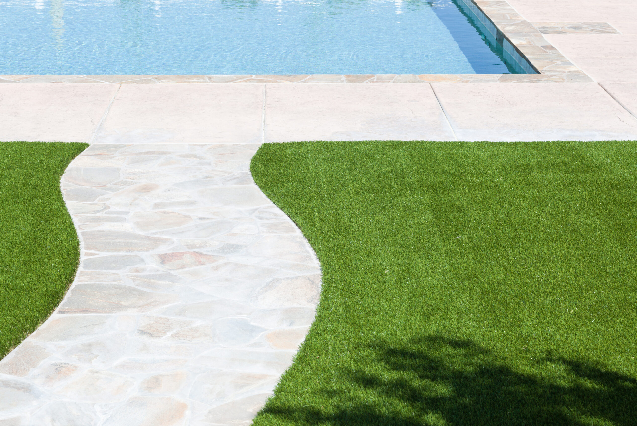 new-artificial-grass-installed-near-walkway-and-pool-stockpack-adobe-stock.jpg